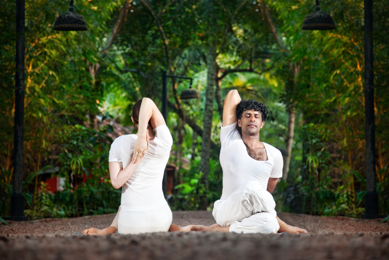 Couple yoga gomukhasana cow pose