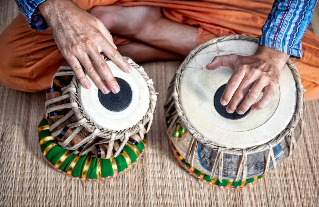 Man playing on traditional Indian tabla drums close up