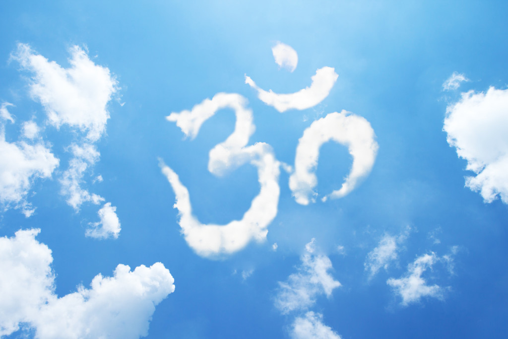 Om symbol clouds shaped on sky.